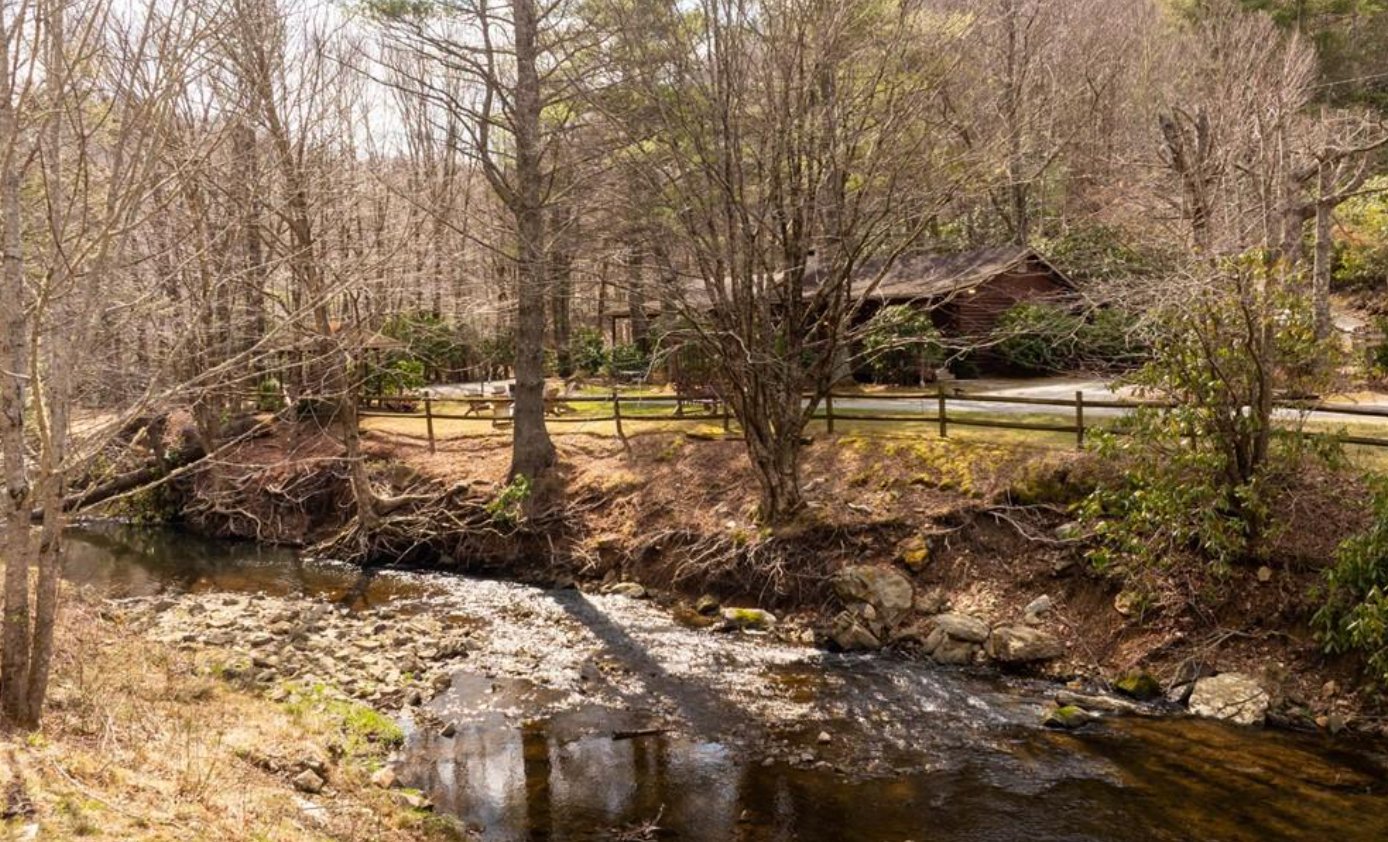 Middle Fork Creek frontage with cabin and rustic fence in background